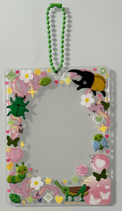 Pink and white background with bugs, flowers, and sparkles. Green chain.